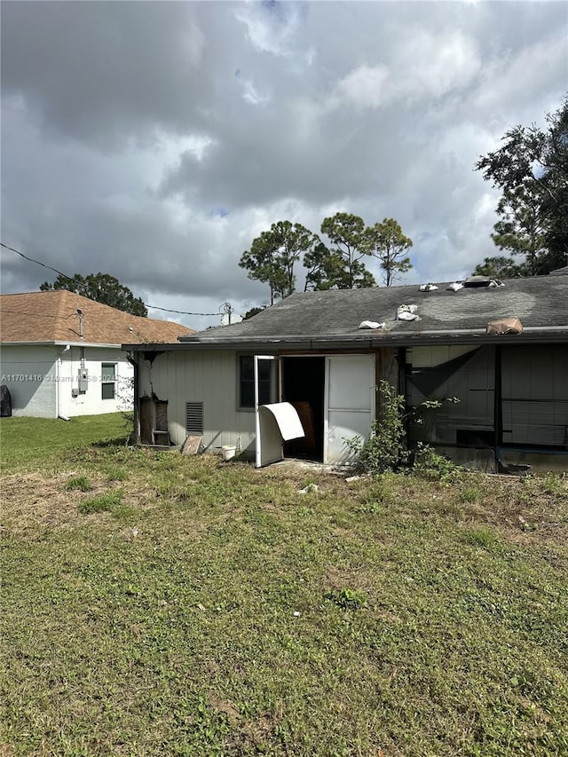 rear view of house with a lawn