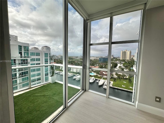 unfurnished sunroom with a water view