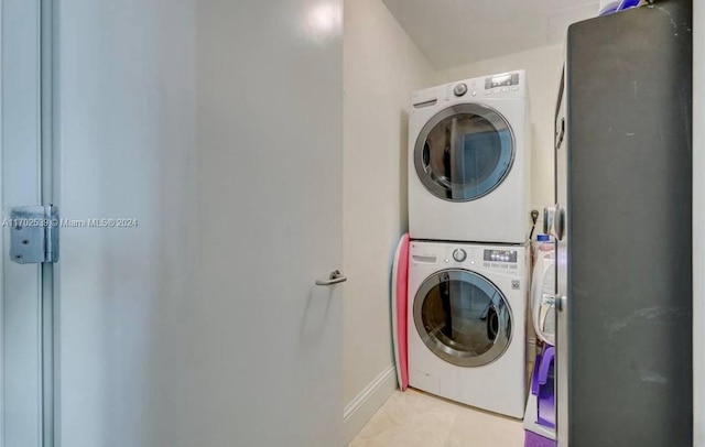 washroom featuring stacked washer / dryer