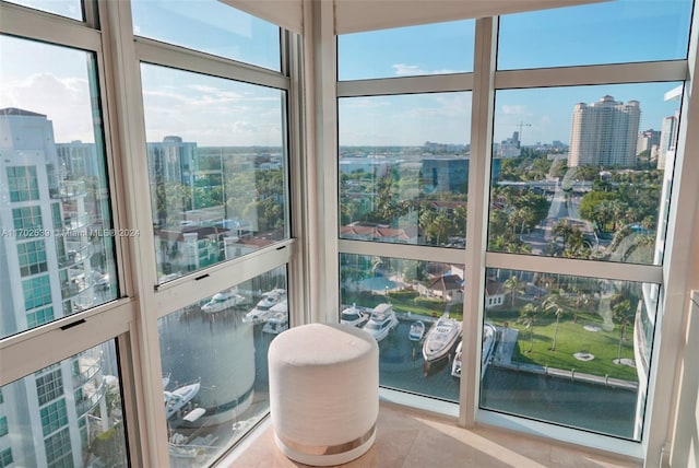 sunroom featuring a water view