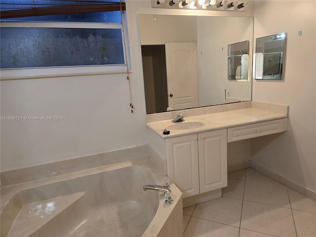 bathroom featuring tile patterned floors, a bathtub, and vanity