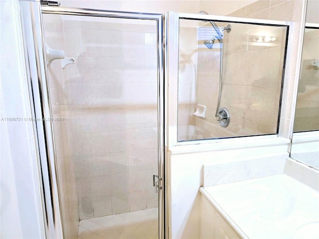 bathroom featuring vanity and a shower with shower door