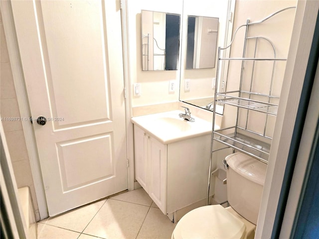 bathroom featuring tile patterned flooring, vanity, and toilet