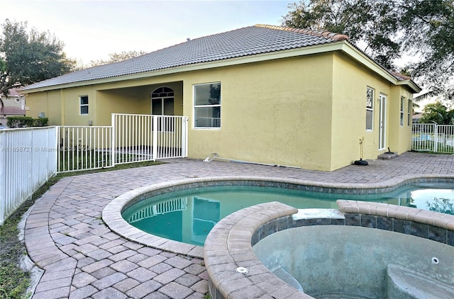 view of swimming pool featuring an in ground hot tub and a patio