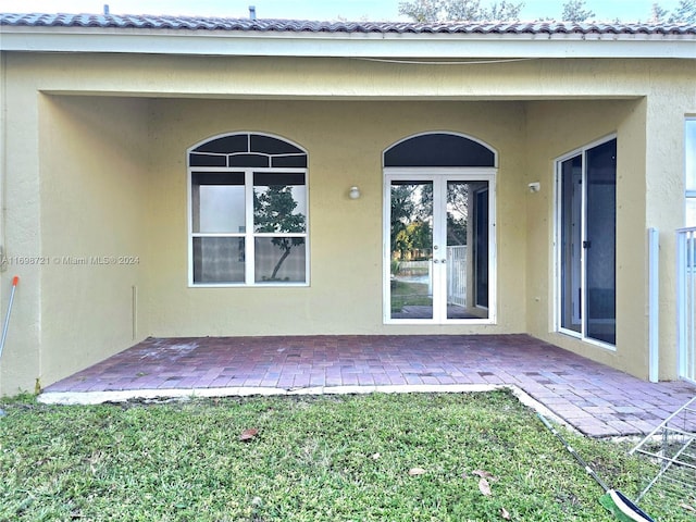 back of property with french doors and a patio