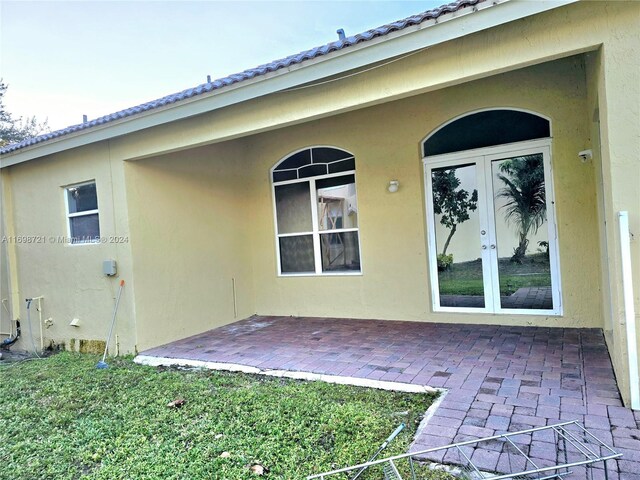 rear view of house featuring french doors and a patio area