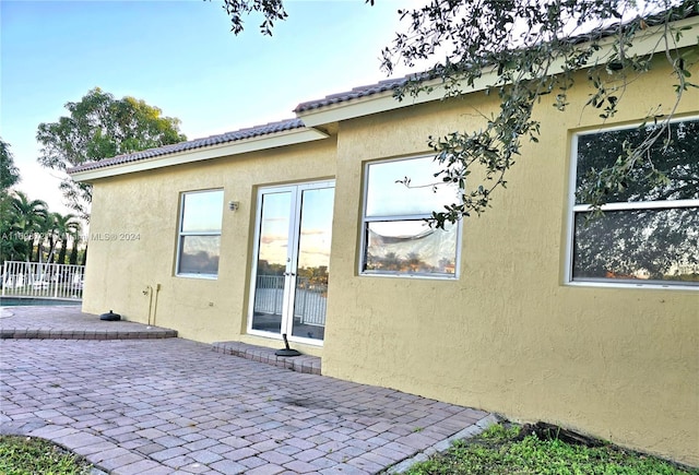 view of side of home with a patio