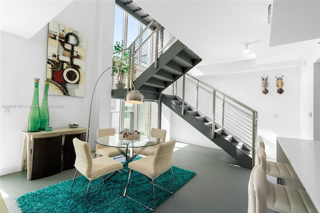 staircase featuring concrete floors