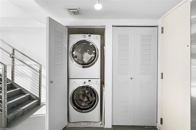 washroom featuring stacked washer / drying machine