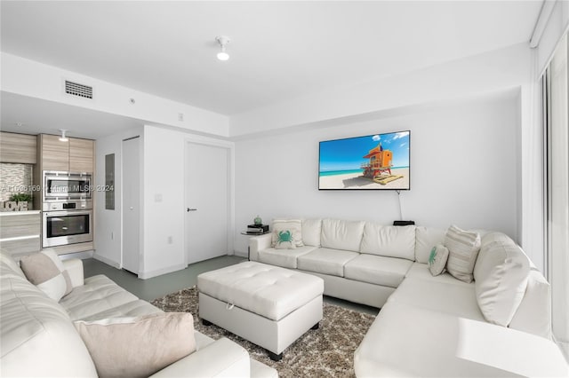 living room featuring concrete flooring