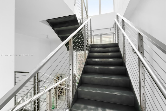 stairs with concrete flooring