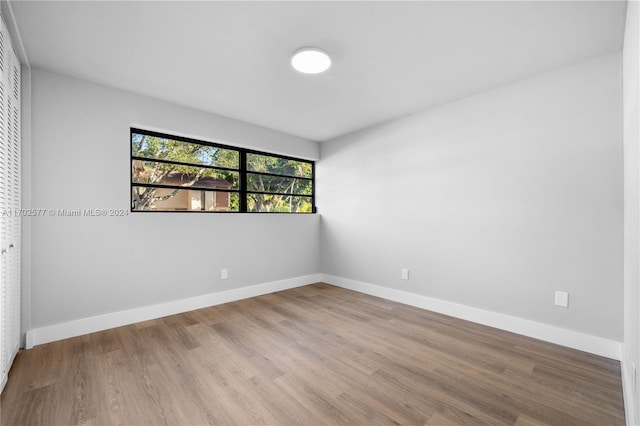 unfurnished room with light hardwood / wood-style floors