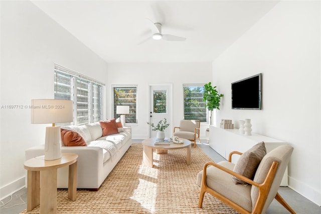 living room featuring a wealth of natural light and ceiling fan