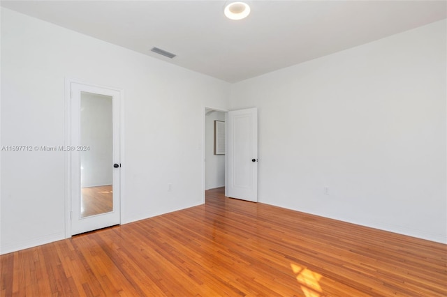 spare room featuring wood-type flooring