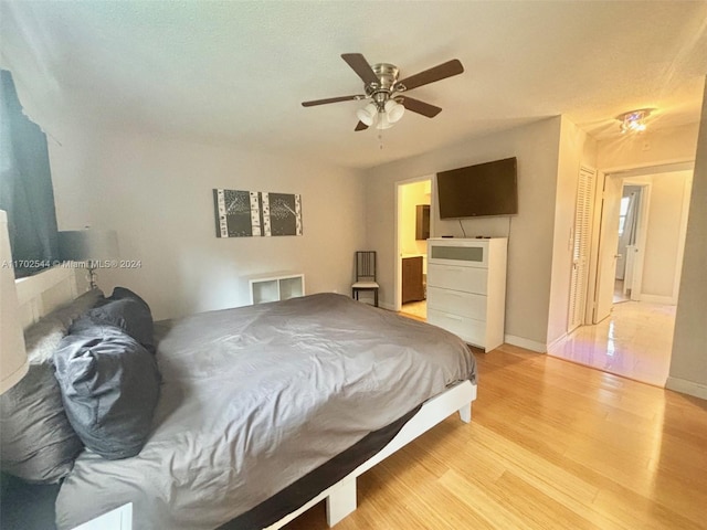 bedroom with ceiling fan and light hardwood / wood-style flooring