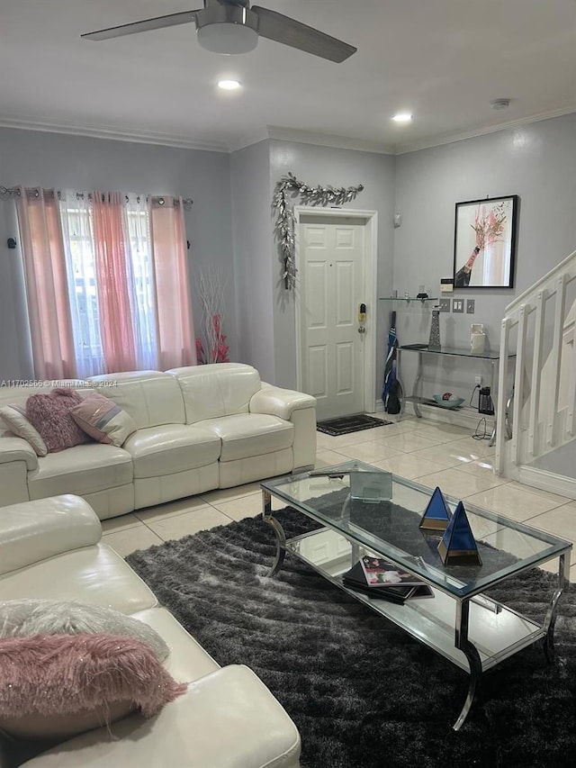 living room featuring crown molding, light tile patterned floors, and ceiling fan