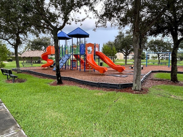 view of playground with a lawn