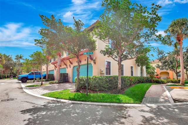 mediterranean / spanish-style house with a garage