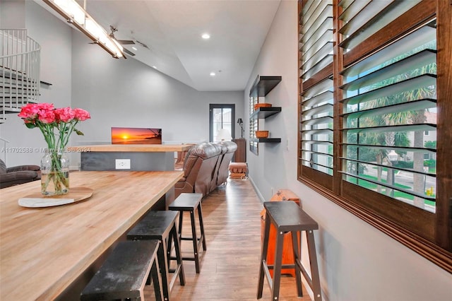 dining room with lofted ceiling and light hardwood / wood-style flooring