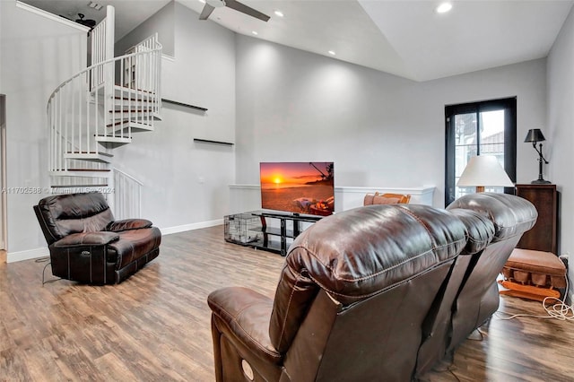 living room with wood-type flooring, high vaulted ceiling, and ceiling fan