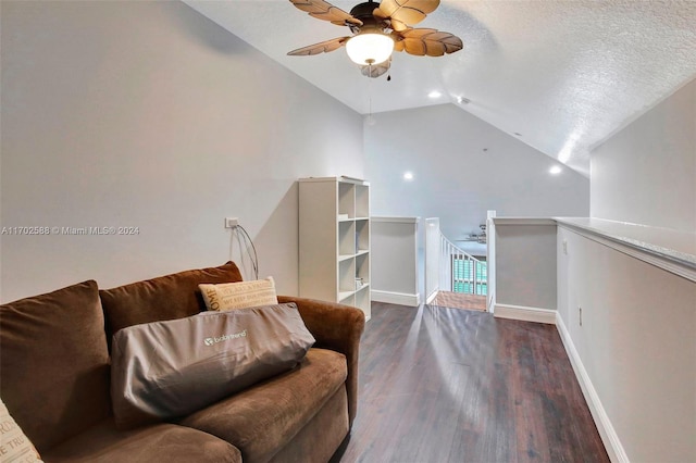 living area with ceiling fan, lofted ceiling, a textured ceiling, and dark wood-type flooring