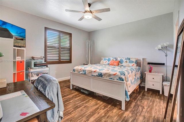 bedroom with ceiling fan and dark hardwood / wood-style floors