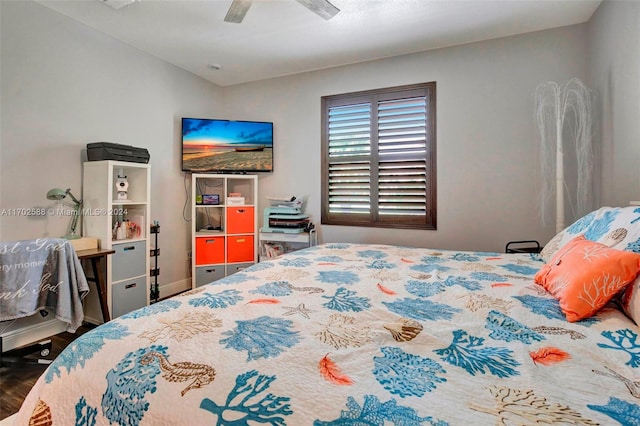 bedroom with ceiling fan, dark wood-type flooring, and lofted ceiling