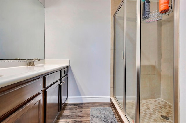 bathroom featuring vanity, a shower with shower door, and hardwood / wood-style flooring