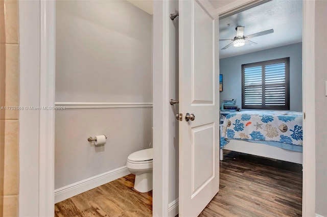 bathroom featuring wood-type flooring, toilet, and ceiling fan