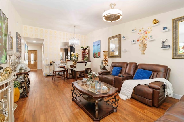 living room featuring hardwood / wood-style floors and an inviting chandelier