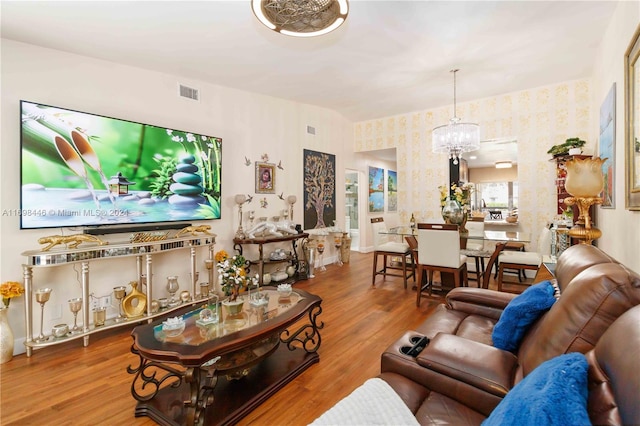 living room featuring a chandelier and wood-type flooring