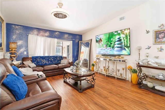 living room with hardwood / wood-style flooring and vaulted ceiling