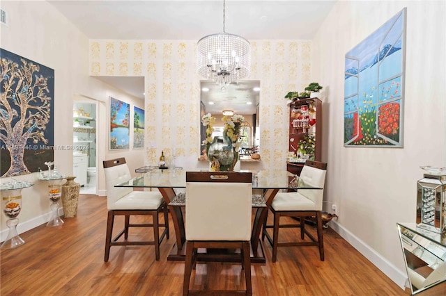 dining area featuring a chandelier and dark hardwood / wood-style floors