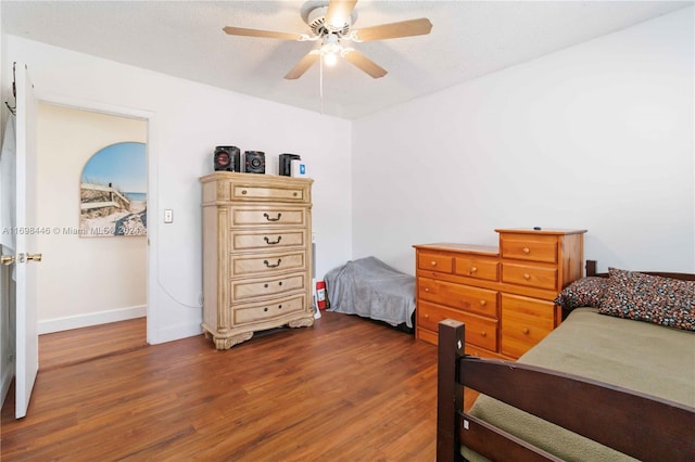 bedroom featuring ceiling fan and dark wood-type flooring