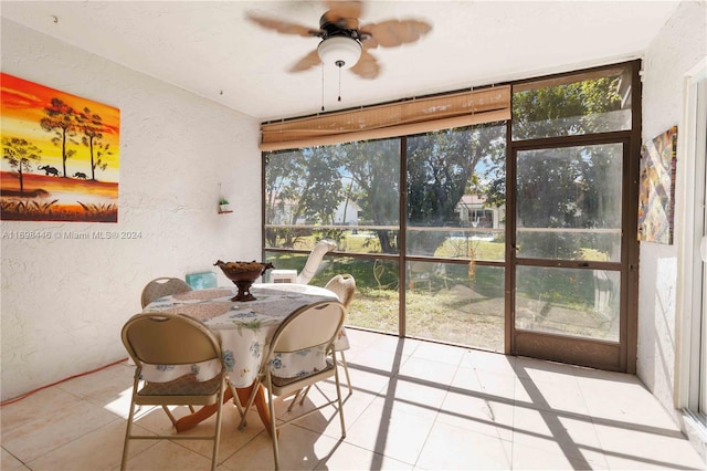 sunroom featuring ceiling fan and a healthy amount of sunlight