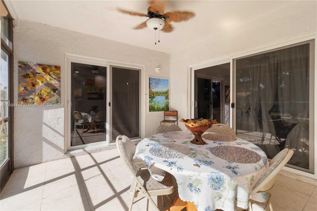 sunroom / solarium featuring ceiling fan