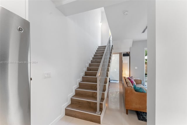 stairway with tile patterned flooring