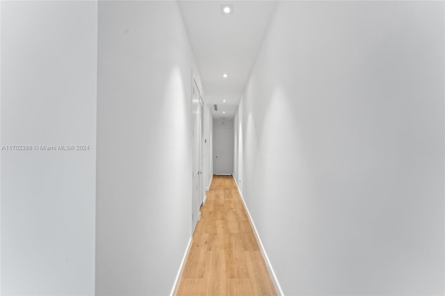 corridor with light hardwood / wood-style floors