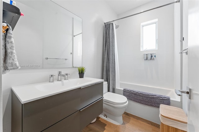 full bathroom with vanity, wood-type flooring, shower / tub combo, and toilet