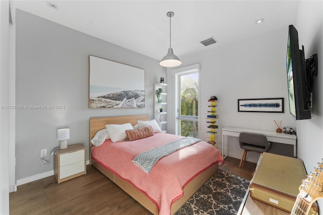 bedroom featuring dark hardwood / wood-style flooring