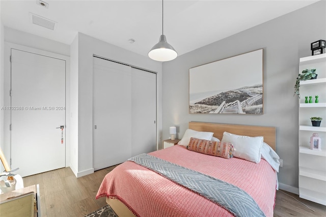 bedroom with a closet and light hardwood / wood-style flooring