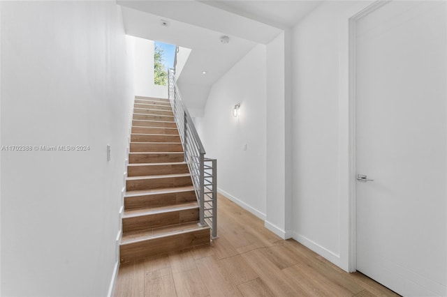 stairway featuring wood-type flooring