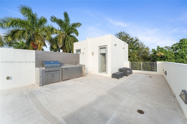 view of patio with a grill, sink, and exterior kitchen