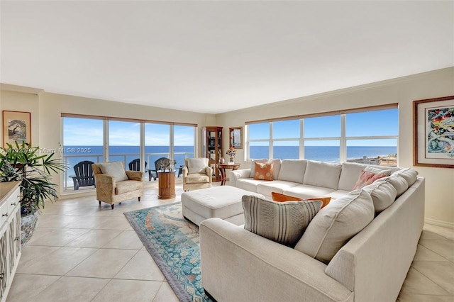 tiled living room featuring a water view