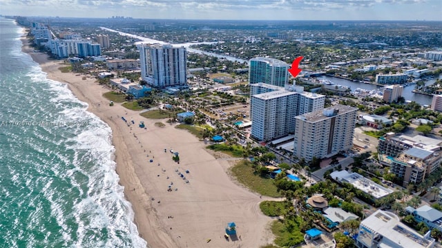 bird's eye view with a water view and a beach view