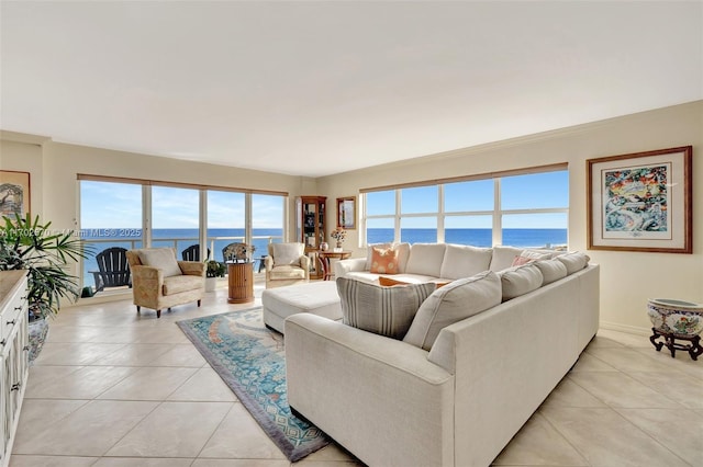 living room featuring a water view and light tile patterned floors