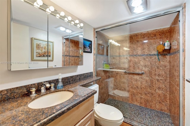 bathroom with vanity, toilet, and an enclosed shower