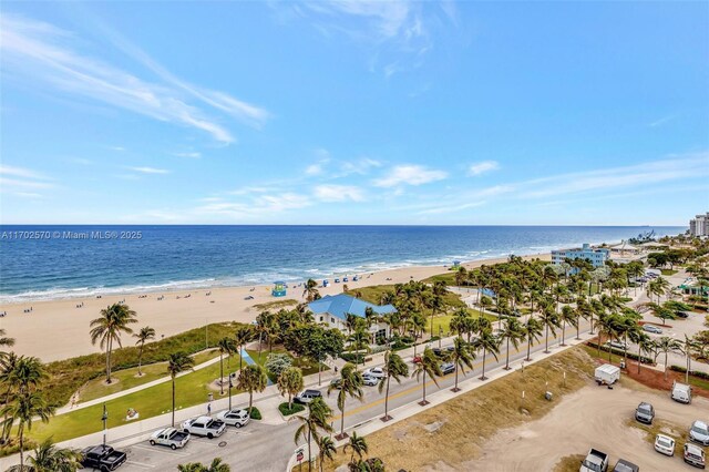 aerial view with a water view and a beach view