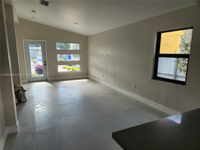 unfurnished room featuring lofted ceiling