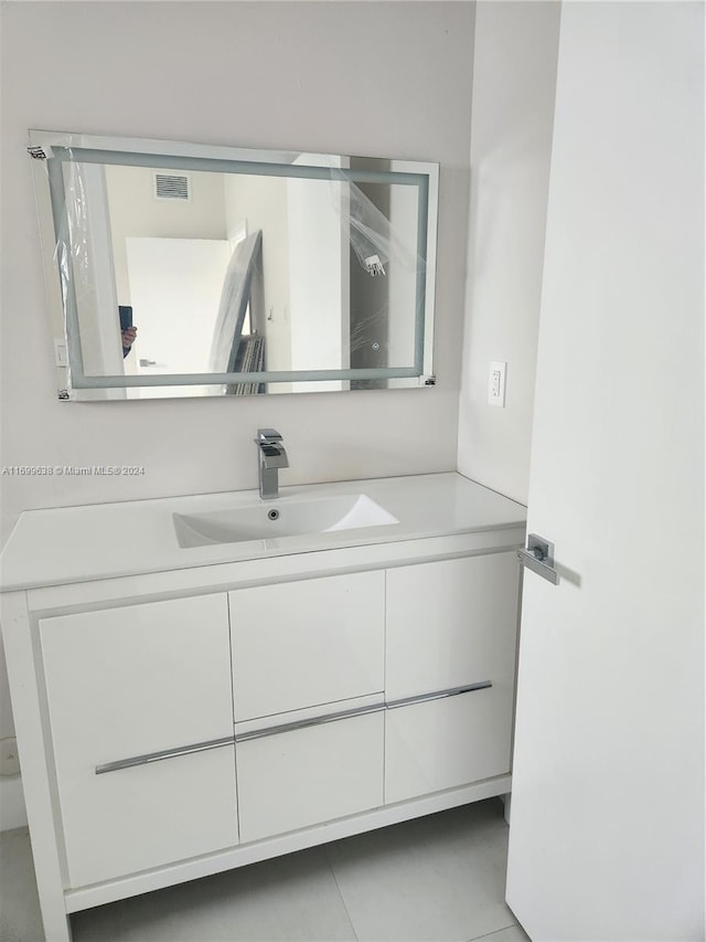 bathroom with tile patterned flooring and vanity